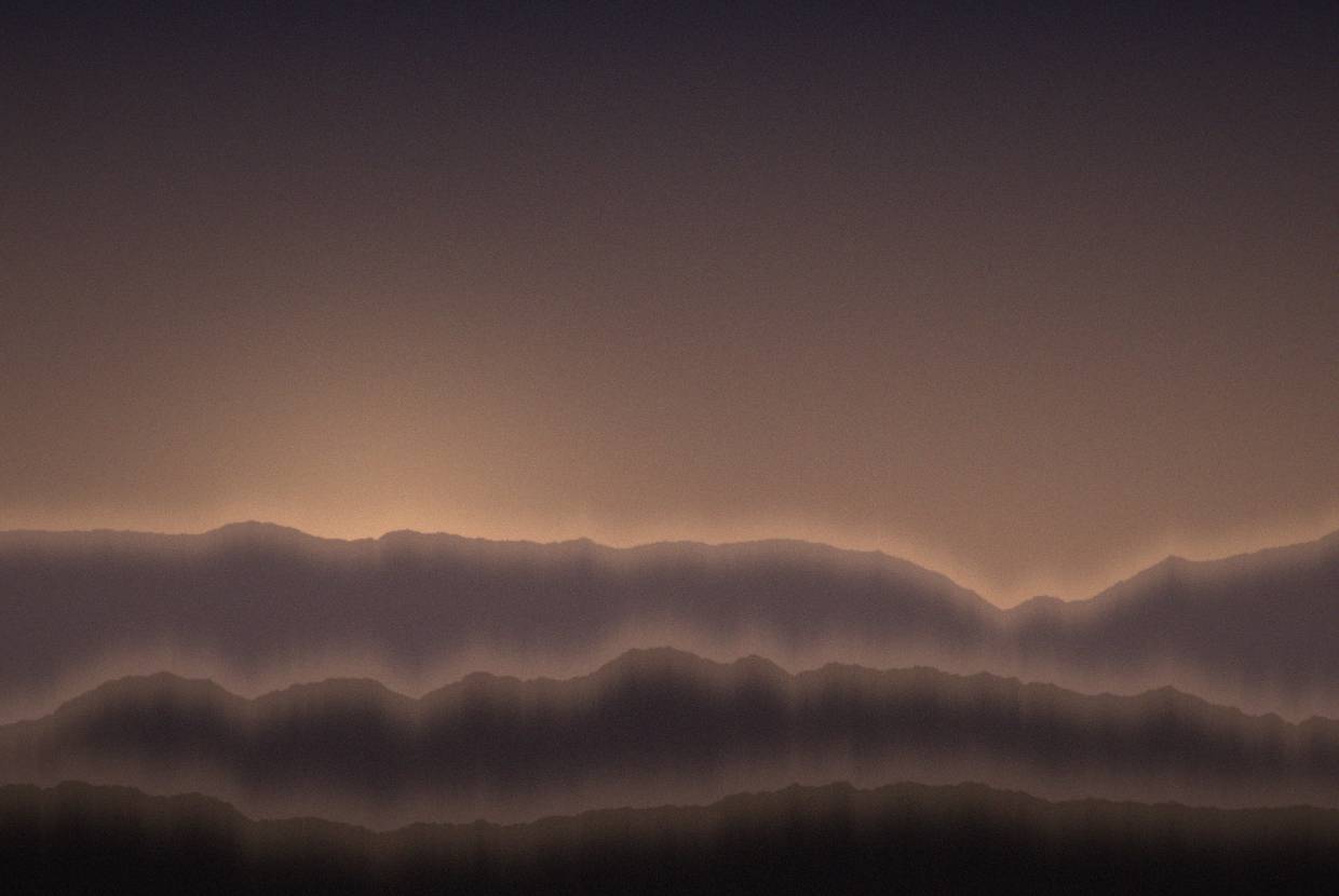 Sunset over water with distant headlands